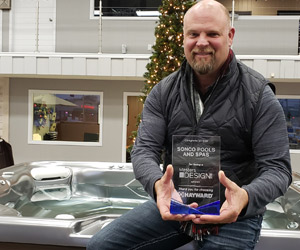 Mike Peterson with Sonco Pools and Spas in Rockford, Illinois holding Masters of Design award for pool design & installation