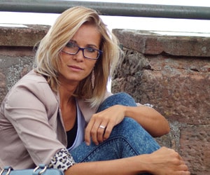 woman sitting with her knees up looking at the camera