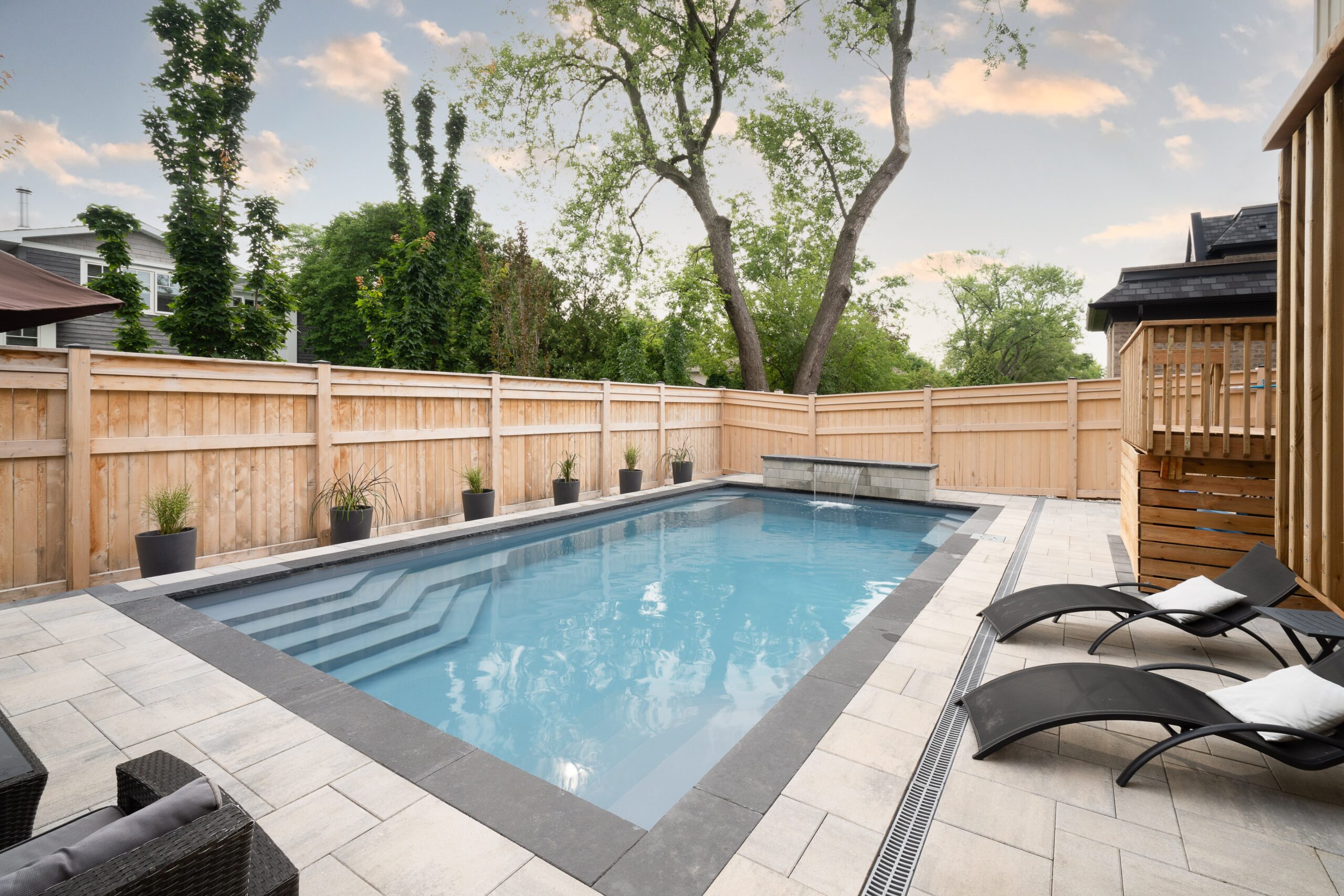 fiberglass pool installation in a fenced in yard